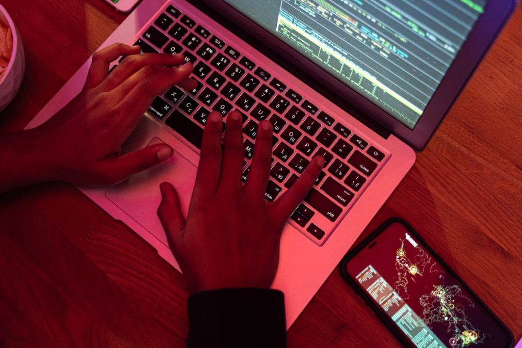 person using laptop with code on screen